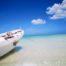 Fischerboot mit Möven am Strand der Isla Holbox in Mexiko